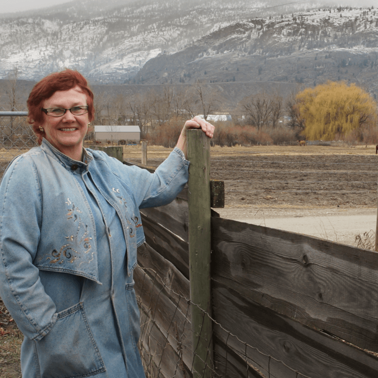 Portrait of happy mature woman with mountains in background