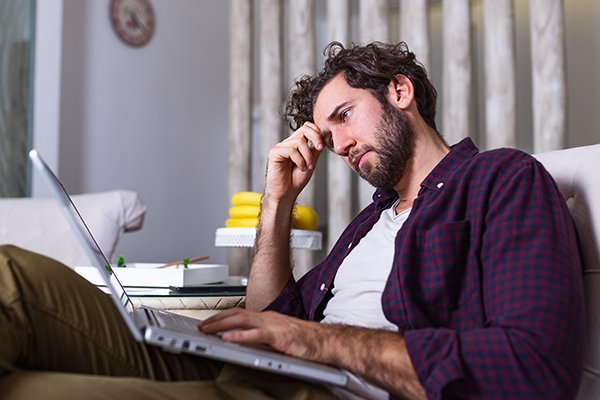 A  man considers whether to file Bankruptcy