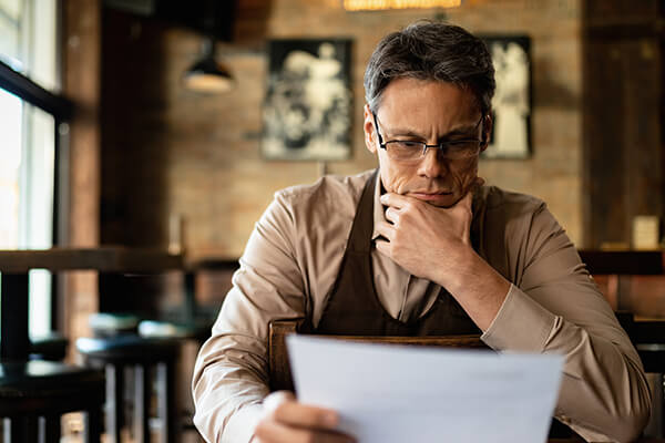 A man reviews his small businesses' financial statements