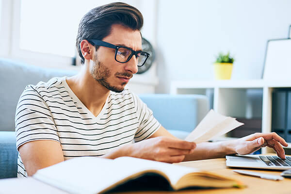 A man views his expenses to look for ways to save money