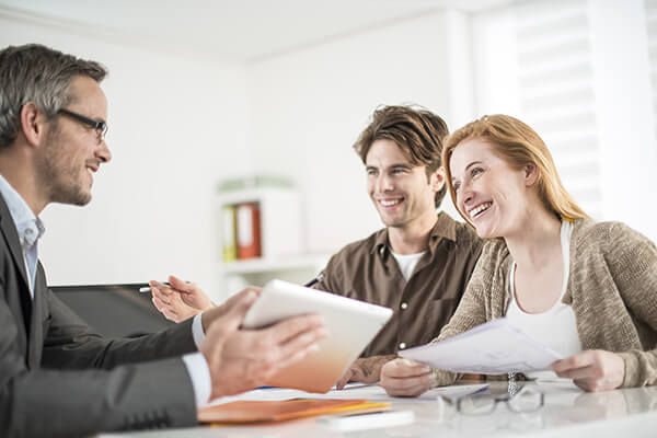 A couple speaks with a credit counsellor about a debt management plan 