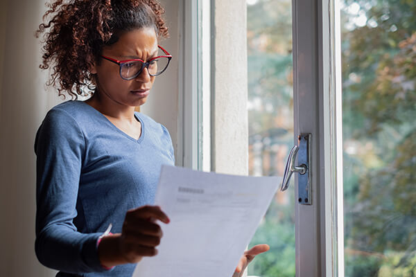 Worried woman looking at bills