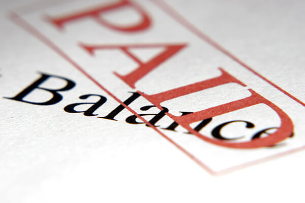 An image of a debt letter with the word "Paid" stamped across it. 