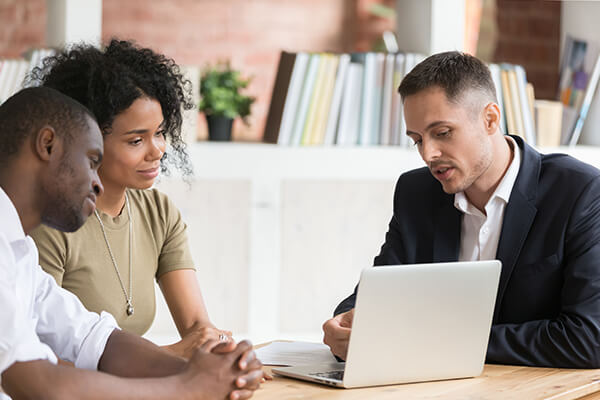 Married couple talking with financial advisor on a meeting