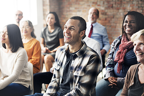 A group of people gathered for an in-person financial workshop.