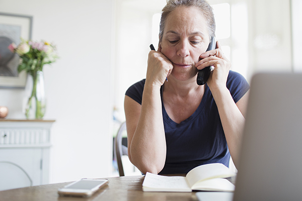 A woman negotiates her credit card debt over the phone 