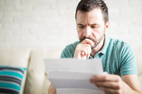 A man reads a notice of claim letter