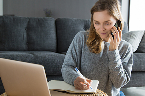 A woman talking to a credit counsellor over the phone.