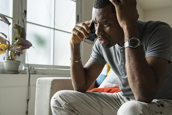 Worried man talking on phone