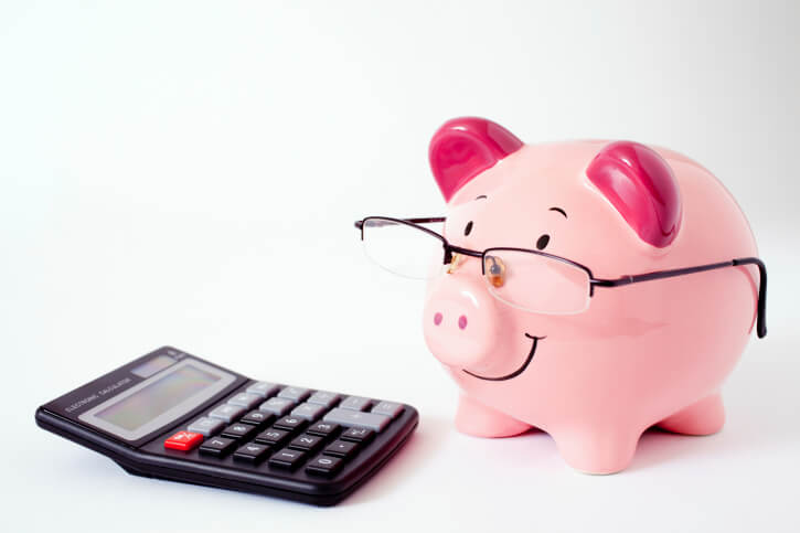 A piggy bank with a calculator representing budgeting, managing money, and home finances.