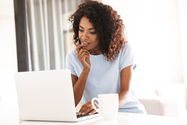 Woman on a laptop attending an online professional development workshop and webinar.