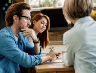 A couple meeting for credit counselling in Canada with a credit counsellor.