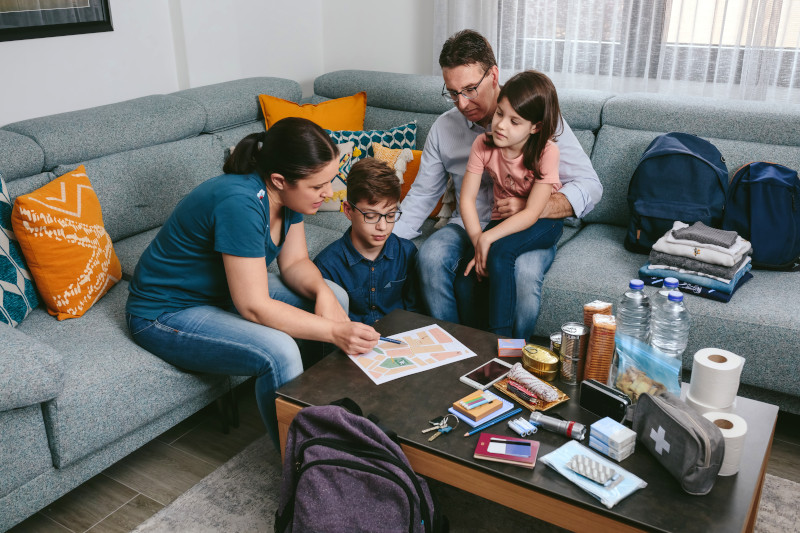 A family making an emergency plan to prepare for a natural disaster.