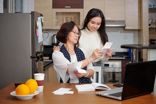 Mother And Daughter Doing Paperwork