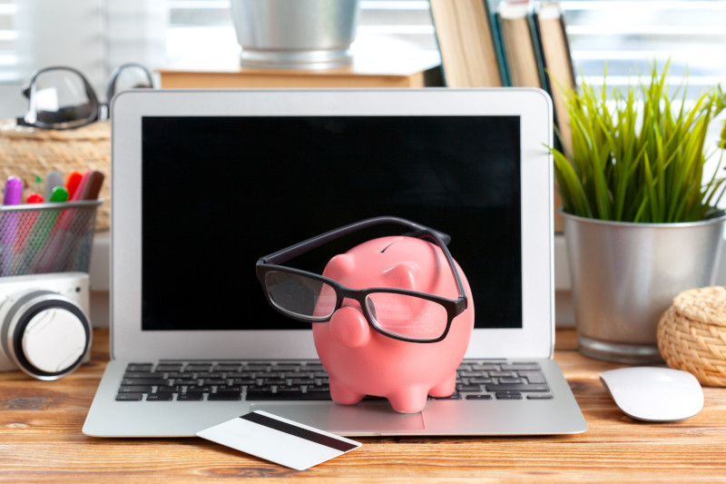 Budgeting Piggy Bank And Laptop