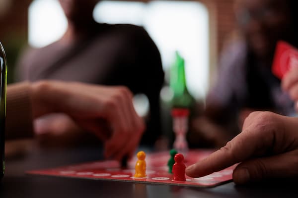 Close Up Of People Hands Moving Plastic Figurines